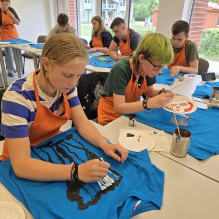 youth painting shirts put on tables